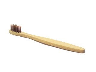 wooden toothbrush with brown pile on a white background isolated