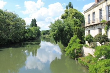 Fototapeta na wymiar Beautiful reflection in river Loir in Montoire sur le Loir village near Lavardin, Loir et Cher, France
