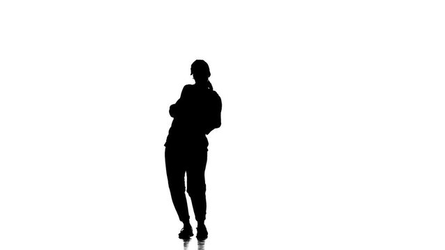 black silhouette on a white background, young beautiful  woman dancer dancing hip hop, contemporary, modern street dance, slow motion