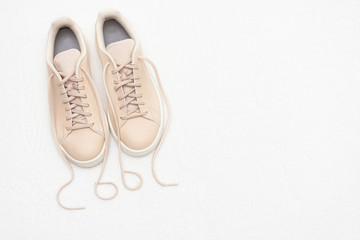 Beige women's sneakers,  inscription cool, white background, copy space, top view