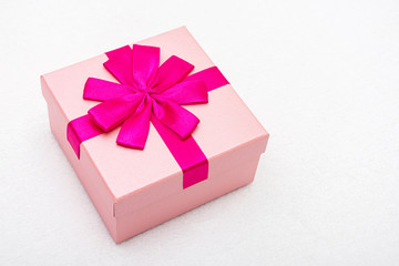 Beautiful gift with pink ribbon for Birthday, white background, close-up, top view