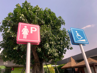 ladies parking  sign for toilet on road.