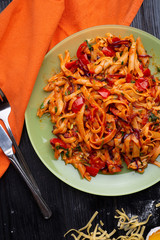  italian pasta with tomatos and herbs on dark wooden table. italian pasta recipe.  flat lay