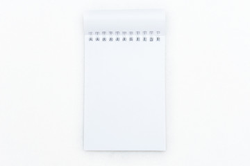 Notepad on white background, top view, copy space
