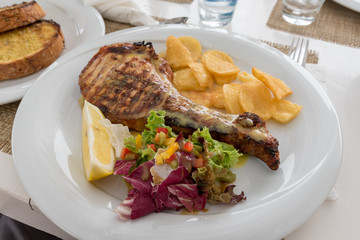 Chop with salad potatoes and lemon