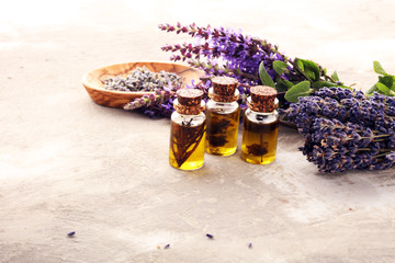 lavender herbal oil and lavender flowers. bottle of lavender massage oil for aromatherapy treatment