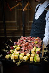 catering services. The waiter keeps snacks - meat and cheese