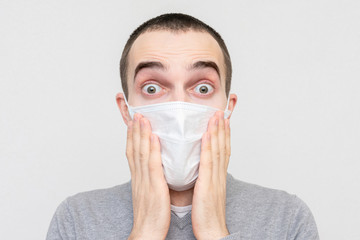 Afraid man with a medical mask to avoid infection with coronavirus, portrait, close-up