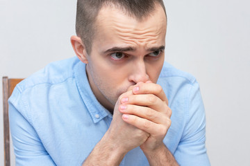 Religious baptist man prays sitting down, portrait, closeup