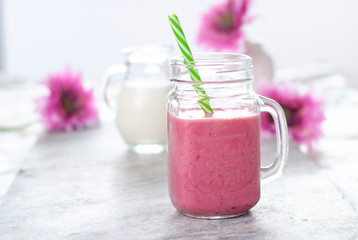 Beautiful light fruit smoothie in the glass with white and pink colors. Berries drink. Milk natural organic products