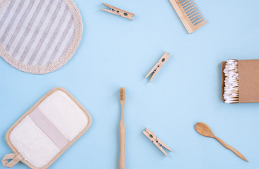 Zero Waste Set For Bathing On Light Blue Background. Natural sisal brush, wooden comb, sea salt, bamboo toothbrush, washcloth and cotton buds.    Top view, flat lay,