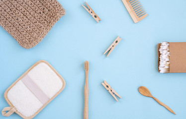 Zero Waste Set For Bathing On Light Blue Background. Natural sisal brush, wooden comb, sea salt, bamboo toothbrush, washcloth and cotton buds.    Top view, flat lay,