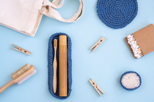Zero Waste Set For Bathing On A Light Blue Background.   Zero Waste Cotton Bag. Natural sisal brush, wooden comb, sea salt, bamboo toothbrush, washcloth and cotton swabs.  Top view, flat lay