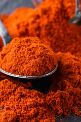 aromatic ground paprika on a dark stone background