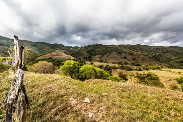 dramatic image of fields and farms in the rural countryside of the caribbean mountains in the dominican republic.