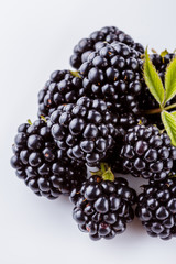 juicy blackberries on a white acrylic background