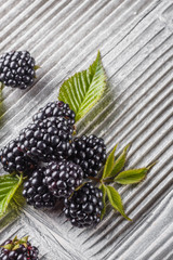 juicy blackberries on gray wooden rustic background