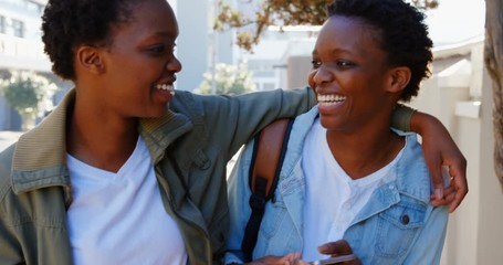 Twin sisters walking in the city - Powered by Adobe