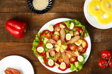 Pan-Asian salad with cherry tomatoes, smoked chicken, pineapple and sesame seeds