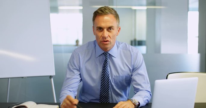 Businessman explaining chart in a modern office