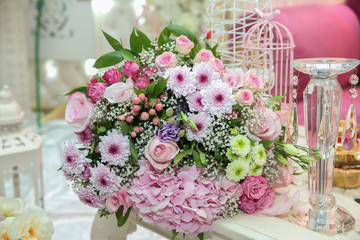 Beautiful bouquet of colored roses wrap bulurred background . Multi-colored flower bouquet .