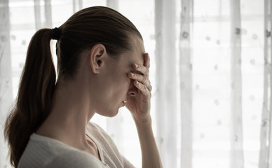 Young woman at home, feeling upset, and sad