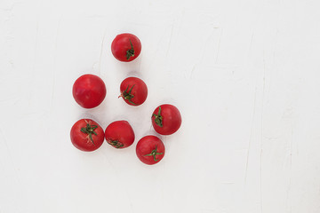 Naklejka na ściany i meble Tomatoes on a white textural background.
