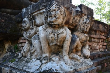 Fototapeta na wymiar Beautiful sculptures at the ancient temple Wat Mahathat in the historical park of Sukhothai