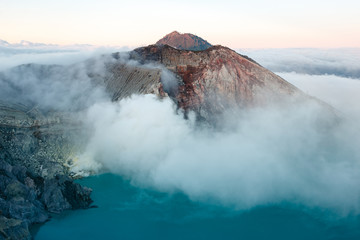 Toxic volcano Ijen on Java island, Indonesia. Foggy sunrise, another planet landscape.