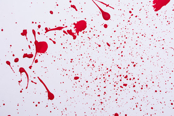 Red paint splashes. Colorful red paint explosion on white background, texture