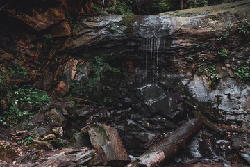 dry waterfall in the mountains on a summer day wet stones