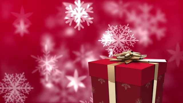 Animation of white snowflakes falling on a red background with a wrapped gift box with golden ribbon
