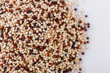 mix of quinoa grains on white acrylic background
