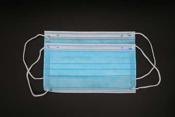 Obraz premium blue medical face masks on black background