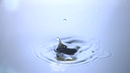 Olives on cocktail stick falling in water - Powered by Adobe