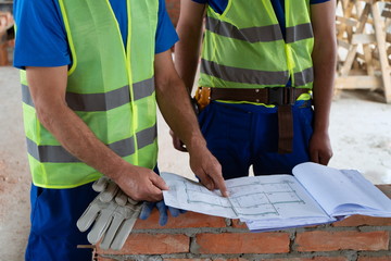 Construction workers control blue-prints image