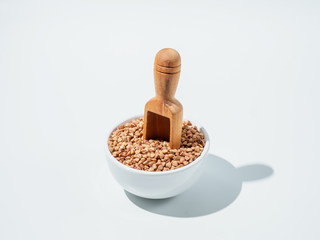 Plate with buckwheat isolated on white background.