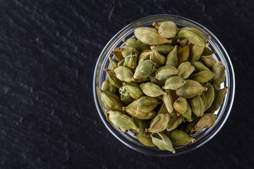 fragrant green cardamom on a dark stone background