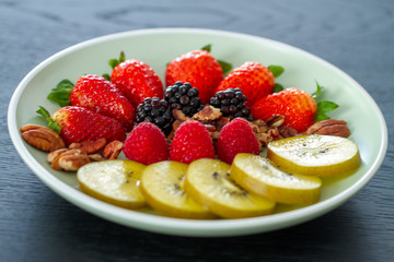 Breakfast plate with fruits and pecan nuts
