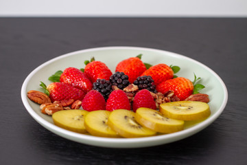 Breakfast plate with fruits and pecan nuts