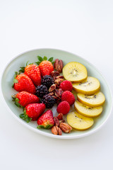 Breakfast plate with fruits and pecan nuts