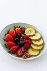 Breakfast plate with fruits and pecan nuts