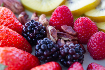 Breakfast plate with fruits and pecan nuts