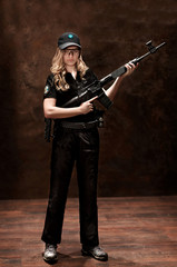  young blonde girl in uniform with gun