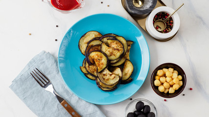 Fried eggplant in the blue plate.