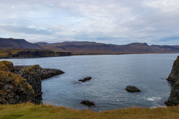 rough landscape with mountains, sea and waterfalls