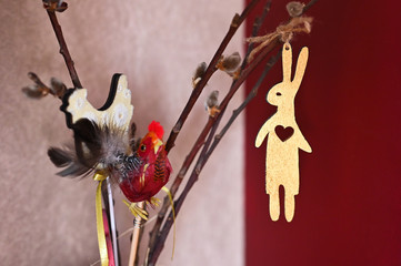 Wooden hare hanging on a branch