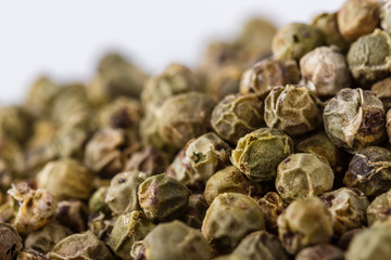 spicy green peppers on white acrylic background