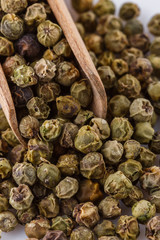 spicy green peppers on white acrylic background