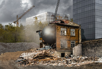 A gray and dusty cityscape of real estate development - an old historic wooden house is being...